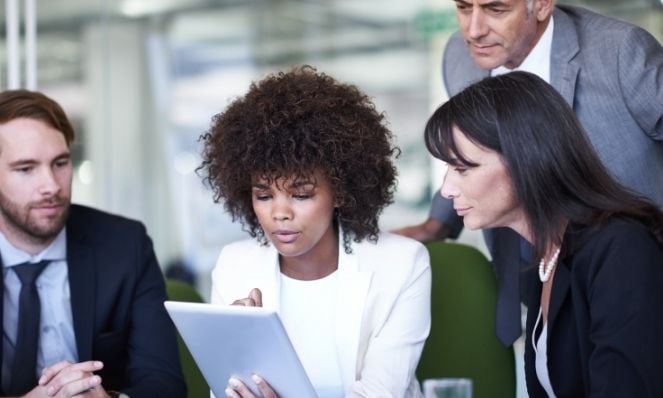 colleagues looking at a tablet