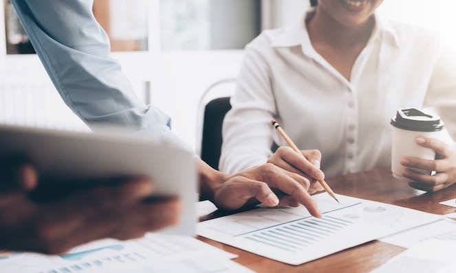 2 people working on a document